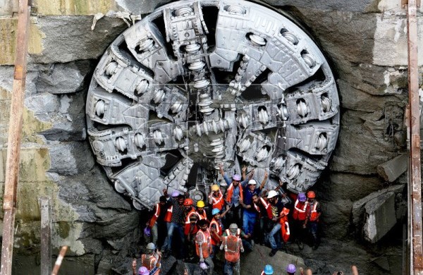 Workers pose for photos in front of Krishna - Photo Copyright: European Pressphoto Agency