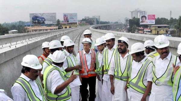 E. Sreedharan with Oomen Chandy on top of Kochi's Metro line - Photo Copyright Indian Express